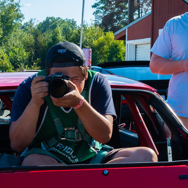 Photographer in back of car