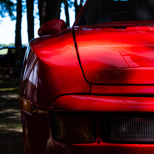 Red Porsche in dappled light