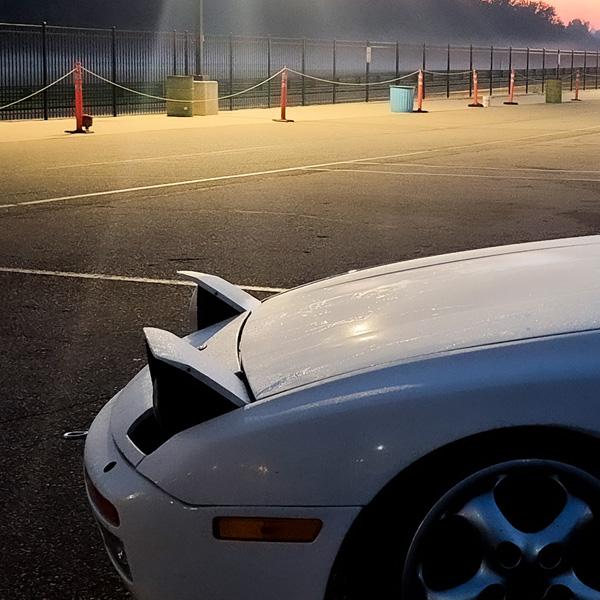 White Porsche at misty track sunrise