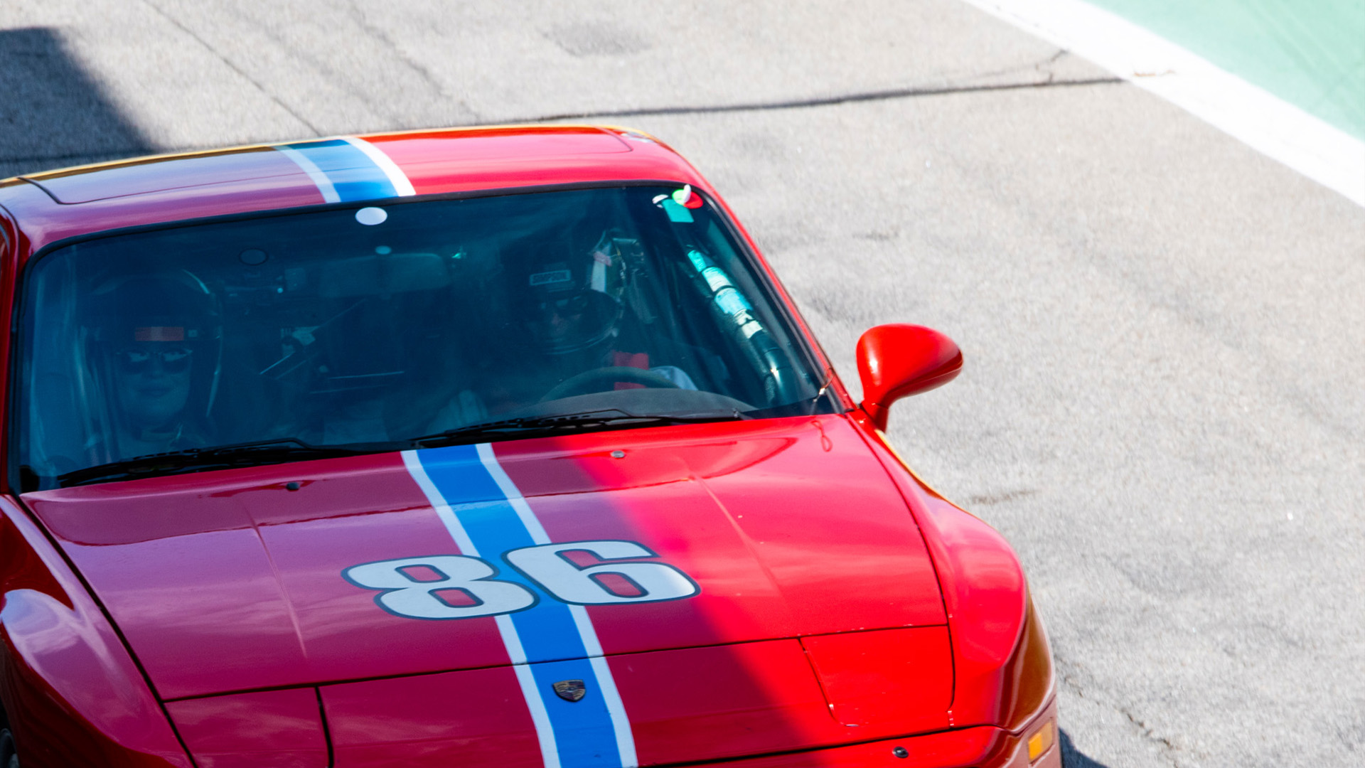 Red race car number 86 on track